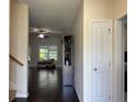 Bright living room featuring hardwood floors, a ceiling fan, and a large window for natural light at 340 Barony Dr., Conway, SC 29526