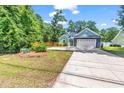 Beautiful home exterior with a well-maintained lawn, driveway, and attractive landscaping at 3846 Journeys End Rd., Murrells Inlet, SC 29576