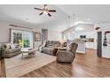 Inviting living room featuring vaulted ceilings, wood floors, and a sliding door for outdoor access at 3846 Journeys End Rd., Murrells Inlet, SC 29576