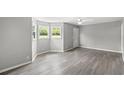 Bright living room with gray walls, lots of natural light, and stylish vinyl floors at 4249 E Highway 9, Loris, SC 29569