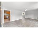 Spacious living room featuring gray walls and modern vinyl floors leading to the kitchen at 4249 E Highway 9, Loris, SC 29569