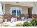 Inviting front porch featuring stone accents, two Adirondack chairs, and a small side table at 428 Arlington Circle, Murrells Inlet, SC 29576