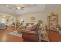 Spacious living room with hardwood floors, trey ceilings, and comfortable leather seating at 428 Arlington Circle, Murrells Inlet, SC 29576
