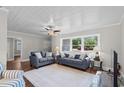 Comfortable living room showcasing hardwood floors, neutral walls, and large window views at 4325 Ellis Ave., Little River, SC 29566
