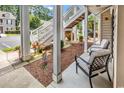 Relaxing covered porch with comfortable seating and view of well-maintained landscaping at 447 Mahogany Dr. # 102, Murrells Inlet, SC 29576