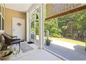 Relaxing screened porch featuring a cozy sitting area and serene backyard views at 468 Papyrus Circle # 468, Little River, SC 29566