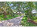 Picturesque home with mature trees, long gravel driveway, and well-manicured lawn at 485 Waterford Dr., Georgetown, SC 29440
