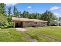 Quaint single-story brick home with an attached carport and a grassy front yard at 5 Dogwood St., Hemingway, SC 29554