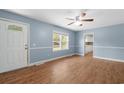 Inviting living room with light blue walls, wood-look flooring, and a ceiling fan at 5 Dogwood St., Hemingway, SC 29554