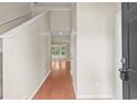 Bright hallway featuring hardwood flooring, access to upstairs, and views of the living room at 5008 Hayes Bay Ct., Murrells Inlet, SC 29576