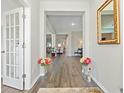 Elegant foyer featuring hardwood floors, a decorative mirror, and an open view into the bright living spaces at 567 Hickman St., Myrtle Beach, SC 29575