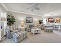 Cozy living room with a ceiling fan, striped furniture, and lots of seaside decorations at 6253 Catalina Dr. # 1824, North Myrtle Beach, SC 29582