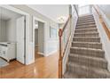 Inviting entryway featuring a carpeted staircase, wood floors, and wainscoting at 670 2Nd Ave. N, North Myrtle Beach, SC 29582