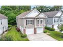 Traditional home showcasing a two-car garage and manicured landscaping at 670 2Nd Ave. N, North Myrtle Beach, SC 29582