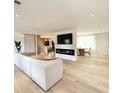 Bright, open-concept living room featuring a modern fireplace, hardwood floors, and neutral decor at 7610 Driftwood Dr., Myrtle Beach, SC 29572