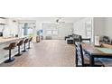 Open-concept living area with hardwood floors, modern furnishings, and natural light at 821 Twickenham Loop, Longs, SC 29568