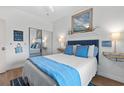 Charming bedroom showcasing a neatly made bed, tasteful decorations, and a mirrored closet at 901 W Port Dr. # 2114, North Myrtle Beach, SC 29582