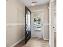Welcoming entryway showcasing wood-look floors and a view of the front porch at 1007 Autumn Dr., Murrells Inlet, SC 29576