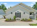 Charming one-story home featuring a landscaped front yard and interesting window design at 1007 Autumn Dr., Murrells Inlet, SC 29576