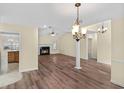 Spacious living room featuring hardwood floors, fireplace, and modern lighting fixtures at 104 Ashton Circle, Myrtle Beach, SC 29588