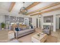 Open-concept living room with exposed beams, modern light fixtures, and seamless flow into a gourmet kitchen at 1054 East Isle Of Palms Ave., Myrtle Beach, SC 29579