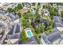 Aerial view showcasing condos with a pool, pond, mature trees, and a well-maintained community at 1058 Sea Mountain Hwy. # 102, North Myrtle Beach, SC 29582