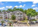 Apartment complex featuring covered walkways, brick accents, ample parking and well-maintained landscaping at 1058 Sea Mountain Hwy. # 102, North Myrtle Beach, SC 29582