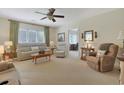Comfortable living room with neutral decor, plush seating, and a ceiling fan at 112 Birchwood Ln., Conway, SC 29526