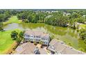 A captivating aerial view of townhomes bordering a scenic lake and lush golf course at 1907 Enclave Ln. # 1907, North Myrtle Beach, SC 29582