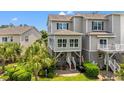 Beautiful backyard with a patio, tropical landscaping, and serene green space at 1907 Enclave Ln. # 1907, North Myrtle Beach, SC 29582