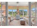 Bright sun room features tranquil pond views and comfortable, stylish furnishings at 1907 Enclave Ln. # 1907, North Myrtle Beach, SC 29582