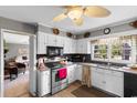 Cozy kitchen featuring white cabinets, stainless steel appliances, and a ceiling fan at 207 Green Lake Dr., Myrtle Beach, SC 29572