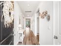 Inviting hallway with wood floors and decor that leads to the living areas, providing a welcoming entrance to the home at 2438 Polaris Path, Myrtle Beach, SC 29577
