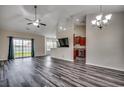 Spacious living room featuring modern plank floors, ceiling fan, recessed lighting, and sliding glass doors to backyard at 365 Lenox Dr., Conway, SC 29526