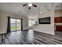 Bright living room boasting plank floors, vaulted ceiling, large windows, and seamless flow to the dining area and kitchen at 365 Lenox Dr., Conway, SC 29526
