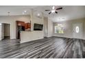 Open-concept living area with modern plank flooring, high ceilings, and a seamless transition to the kitchen and dining area at 365 Lenox Dr., Conway, SC 29526