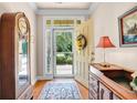 Welcoming entryway features a bright front door with a wreath, hardwood floors, and elegant furniture accents at 431 Huntington Lake Circle # 80, Pawleys Island, SC 29585