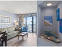 Comfortable living room with balcony overlooking the ocean and artistic décor at 4800 S Ocean Blvd. # 1008, North Myrtle Beach, SC 29582