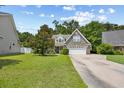 Traditional-style home with a well-manicured lawn and a two-car garage at 509 June Bug Ct., Myrtle Beach, SC 29588