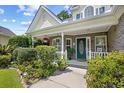 Inviting front porch with brick accents, lovely landscaping, and a charming entrance at 509 June Bug Ct., Myrtle Beach, SC 29588