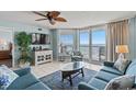 Inviting living room with comfortable seating, stylish decor, and a large sliding glass door to the balcony at 5404 N Ocean Blvd. # 11-D, North Myrtle Beach, SC 29582