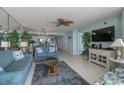 Bright living room with an open floor plan, tile floors, and a full mirrored wall at 5404 N Ocean Blvd. # 11-D, North Myrtle Beach, SC 29582