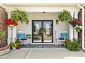 Inviting front porch with double doors, rocking chairs, hanging plants, and charming decor at 5904 Bridlewood Rd., North Myrtle Beach, SC 29582