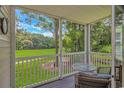 Covered porch with views of golf course and furnishings at 650 Tupelo Ln. # 5-F, Longs, SC 29568