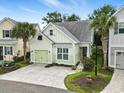 An elevated view of the home showing its landscaping, light green exterior, and one car garage at 6624 Lagoon Pl., Myrtle Beach, SC 29572