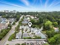 An elevated view of the community, pond, and several homes with a geolocation pin drop at 6624 Lagoon Pl., Myrtle Beach, SC 29572