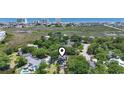 Serene aerial view showcases the home's location near marshland and a distant coastal skyline at 709 Triple Oak Ln., Garden City Beach, SC 29576