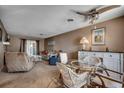Open living area featuring a ceiling fan, glass table, sofa, recliner and a view to the dining area at 808 Myrtle Ct. # 808, North Myrtle Beach, SC 29582