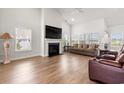 Bright living room featuring a cozy fireplace, hardwood floors, and large windows for natural light at 892 Harrison St., Myrtle Beach, SC 29579