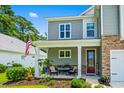 Charming front porch with seating and landscaping, offering a welcoming entrance to the home at 1007 Oak Marsh Ln., North Myrtle Beach, SC 29582